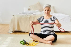 Senior woman exercising with resistance band for weight loss
