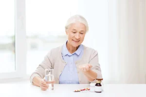 Vitamins for seniors held by an elderly woman
