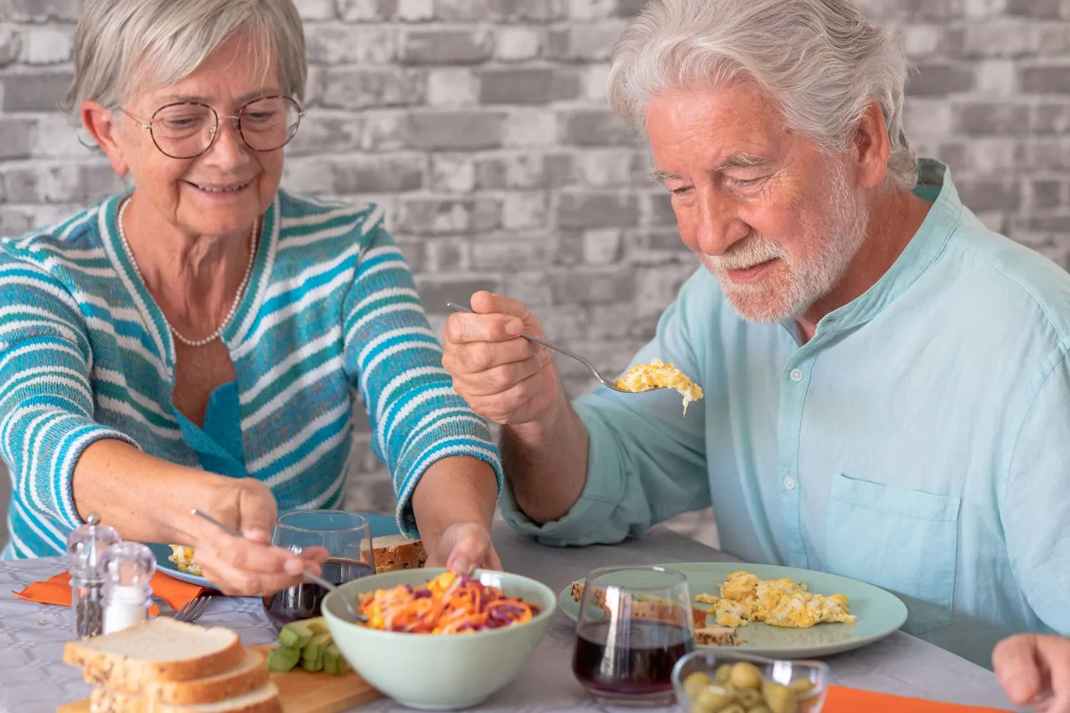 Senior couple enjoying soft food at home.