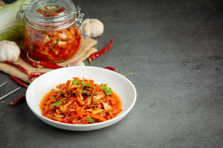 Ready-to-eat kimchi served on a white plate.