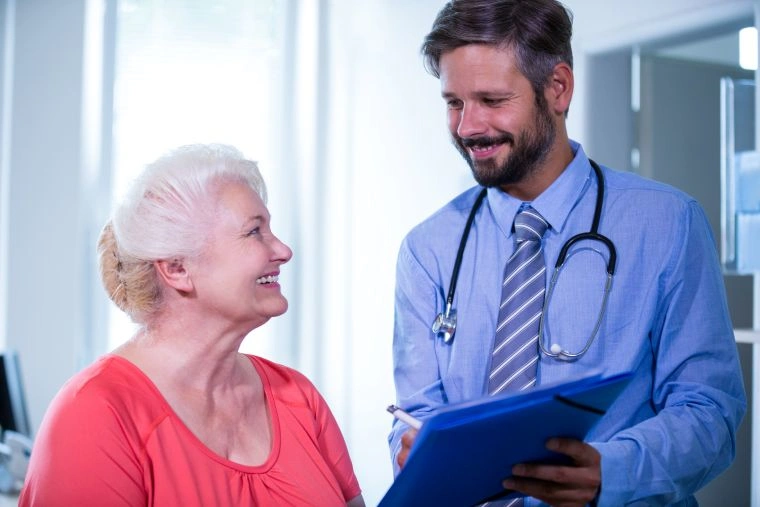 Senior patient consulting with a doctor about Medicare Advantage