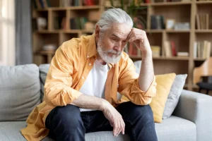 Elderly man worried about anxiety and blood pressure at home